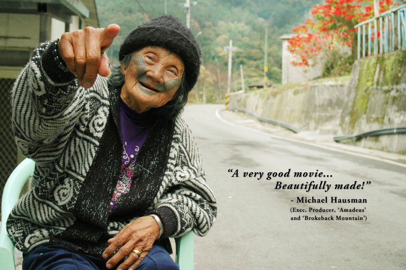 An elder smiles beside a village road. “A very good movie... Beautifully made!” — Michael Hausman.